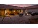 Backyard at dusk features a fire pit and covered patio with seating at 1807 Tawnee Pl, Brandon, FL 33510