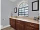 Bathroom featuring wood cabinets, a stone countertop, ample lighting, and a nice window at 1807 Tawnee Pl, Brandon, FL 33510