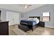 Spacious bedroom with blue accents, a king bed with a navy blanket, and a ceiling fan at 1807 Tawnee Pl, Brandon, FL 33510