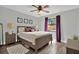 Cozy bedroom with purple accents, wood flooring, and a ceiling fan at 1807 Tawnee Pl, Brandon, FL 33510