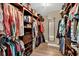 Walk-in closet with custom shelving and rods to maximize storage and organization at 1807 Tawnee Pl, Brandon, FL 33510