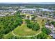 Aerial view of a large community park surrounded by lush greenery, lakes, and residential homes at 1807 Tawnee Pl, Brandon, FL 33510