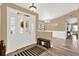 A welcoming foyer with a bench, striped rug, beautiful front door, and hardwood floors leading to the dining area at 1807 Tawnee Pl, Brandon, FL 33510