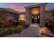 Inviting front entrance with a decorative fountain, colorful landscaping, and a stylish, covered entryway at twilight at 1807 Tawnee Pl, Brandon, FL 33510