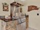 Stainless steel grill on an outdoor counter with stone accents and lighting at 1807 Tawnee Pl, Brandon, FL 33510