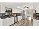 Well lit kitchen featuring stainless appliances, granite countertops, and vinyl flooring at 1807 Tawnee Pl, Brandon, FL 33510