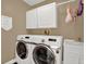 Bright laundry room featuring front load washer and dryer and extra overhead storage at 1807 Tawnee Pl, Brandon, FL 33510