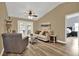 Comfortable living room with vaulted ceilings, a ceiling fan, and access to the backyard through french doors at 1807 Tawnee Pl, Brandon, FL 33510