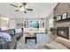 Bright living room with fireplace, wood-look floors, vaulted ceilings, and built-in shelving for storage at 1807 Tawnee Pl, Brandon, FL 33510