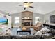 Bright living room with fireplace, wood-look floors, vaulted ceilings, and a ceiling fan at 1807 Tawnee Pl, Brandon, FL 33510