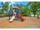 Community playground with slide, swings and climbing area surrounded by mature trees at 1807 Tawnee Pl, Brandon, FL 33510
