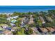 An aerial view showing the community homes, lots of trees, a community pool and beautiful water views at 1836 Bough Ave # C, Clearwater, FL 33760