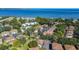 Aerial view of the community featuring mature landscaping, nearby pool and some water views in the area at 1836 Bough Ave # C, Clearwater, FL 33760
