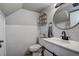 Charming bathroom featuring honeycomb tile, a vanity with a barn door, modern fixtures and a round mirror at 1836 Bough Ave # C, Clearwater, FL 33760
