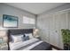 Serene bedroom featuring ample closet space, soft bedding, and a decorative painting at 1836 Bough Ave # C, Clearwater, FL 33760
