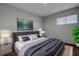 Relaxing bedroom showcasing soft bedding, stylish nightstands, and a decorative painting at 1836 Bough Ave # C, Clearwater, FL 33760