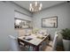Elegant dining room featuring a stylish table with seating for six and a modern chandelier at 1836 Bough Ave # C, Clearwater, FL 33760