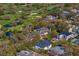 Aerial view showcases surrounding community, lush trees, and golf course of this expansive property at 1903 S Cardenas Ave, Tampa, FL 33629
