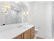 Bright bathroom featuring a glass-door shower, double vanity with light countertop, stylish fixtures, and tile flooring at 1903 S Cardenas Ave, Tampa, FL 33629