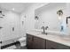 Contemporary bathroom with a walk-in shower, floating vanity with light countertop, and stylish fixtures at 1903 S Cardenas Ave, Tampa, FL 33629