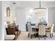 Elegant dining room featuring a round table, chandelier, striped chairs, and built-in hutch at 1903 S Cardenas Ave, Tampa, FL 33629
