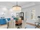 Bright dining room with a round table, chandelier, buffet, and large windows at 1903 S Cardenas Ave, Tampa, FL 33629