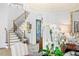 Inviting foyer with hardwood floors, staircase, elegant chandelier, and stylish decor at 1903 S Cardenas Ave, Tampa, FL 33629