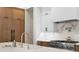 Modern kitchen featuring stainless steel appliances, a marble backsplash, and a pot filler above the range at 1903 S Cardenas Ave, Tampa, FL 33629