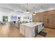 Bright, open-concept kitchen featuring an island with seating, light hardwood floors and a view into the living room at 1903 S Cardenas Ave, Tampa, FL 33629