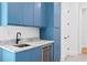 Stylish living room with blue cabinetry, a sink, and beverage cooler at 1903 S Cardenas Ave, Tampa, FL 33629