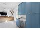 Stylish living room with blue cabinetry, a sink, beverage cooler, and comfortable seating at 1903 S Cardenas Ave, Tampa, FL 33629