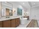A luxurious main bathroom featuring dual vanities, marble floors, and a freestanding soaking tub at 1903 S Cardenas Ave, Tampa, FL 33629