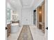 Stunning main bathroom with modern fixtures, dual vanity, soaking tub, and spacious shower at 1903 S Cardenas Ave, Tampa, FL 33629