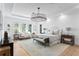 Spacious main bedroom suite features sitting area, stylish light fixture and bright, sunny windows at 1903 S Cardenas Ave, Tampa, FL 33629
