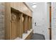 Entryway with custom built-in wooden storage cubbies and bench at 1903 S Cardenas Ave, Tampa, FL 33629