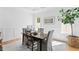 Bright home office featuring hardwood floors, a classic wooden desk, and a decorative houseplant at 1903 S Cardenas Ave, Tampa, FL 33629