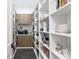 Walk-in pantry with custom shelving for organized storage at 1903 S Cardenas Ave, Tampa, FL 33629