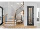Elegant staircase featuring wooden steps, a black iron railing, and stylish wall sconces at 1903 S Cardenas Ave, Tampa, FL 33629