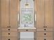 Wooden vanity featuring multiple drawers and cabinets with a lighted mirror, and marble countertop at 1903 S Cardenas Ave, Tampa, FL 33629