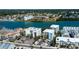 Aerial view of the condos by the intercoastal, surrounded by mature trees and foliage at 19925 Gulf Boulevard # 502, Indian Shores, FL 33785