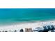 Aerial view showing beachfront homes next to a white sandy beach with ocean at 19925 Gulf Boulevard # 502, Indian Shores, FL 33785
