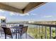 Balcony with table and chairs overlooking scenic waterfront views and a clear blue sky at 19925 Gulf Boulevard # 502, Indian Shores, FL 33785