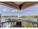 A beautiful waterfront view from the balcony with lush greenery and blue skies at 19925 Gulf Boulevard # 502, Indian Shores, FL 33785