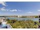 Scenic balcony with a waterfront view featuring boats, lush foliage, and clear blue sky at 19925 Gulf Boulevard # 502, Indian Shores, FL 33785