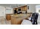 Kitchen featuring granite countertops, wood cabinets, and bar seating, seamlessly connected to living spaces at 19925 Gulf Boulevard # 502, Indian Shores, FL 33785