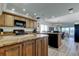 Open-concept kitchen with granite countertops, ample cabinetry, and black appliances, perfect for entertaining at 19925 Gulf Boulevard # 502, Indian Shores, FL 33785