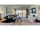 Comfortable living room featuring a leather couch and sliding glass doors to a balcony at 19925 Gulf Boulevard # 502, Indian Shores, FL 33785