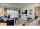 Comfortable living room featuring modern decor, a TV, and access to a balcony with stunning views at 19925 Gulf Boulevard # 502, Indian Shores, FL 33785