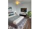 Staged bedroom featuring neutral paint, ceiling fan, modern furniture, and updated flooring at 2007 W De Leon St # C, Tampa, FL 33606