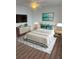 Staged bedroom with neutral paint, updated light fixture, and modern furniture at 2007 W De Leon St # C, Tampa, FL 33606